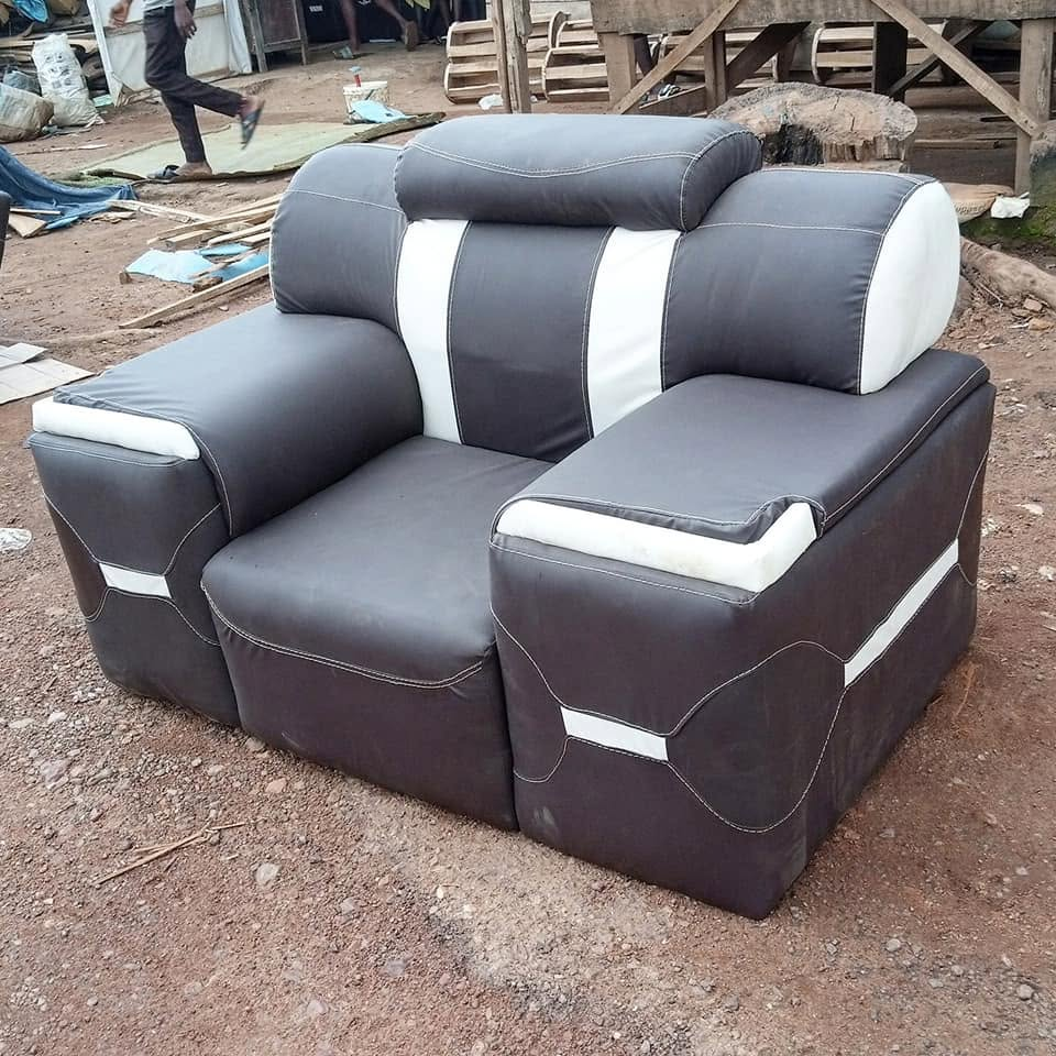 Black and white contrast upholstered armchair shown upright at the workshop