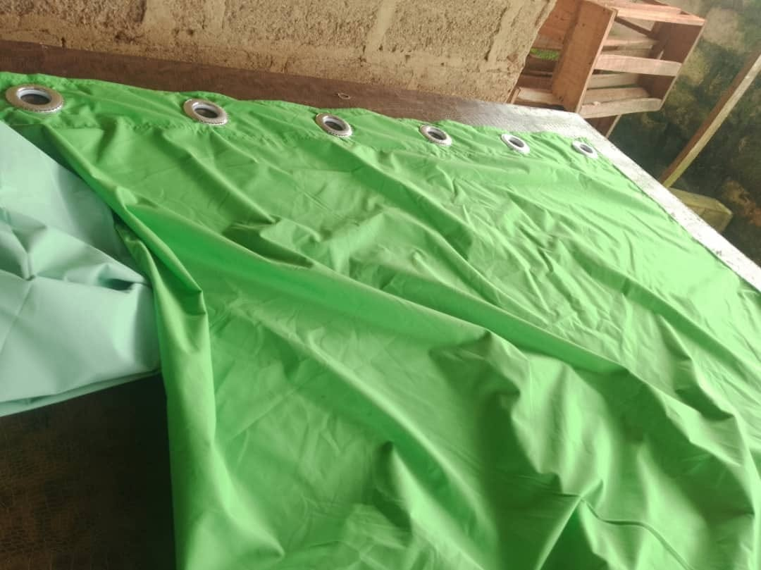 Green curtain fabric prepared for a soft-furnishing installation