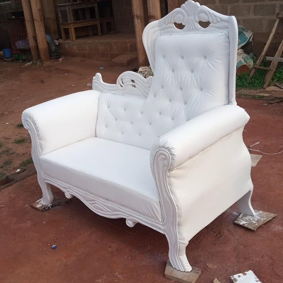 Tall white carved button-tufted chair photographed at the workshop