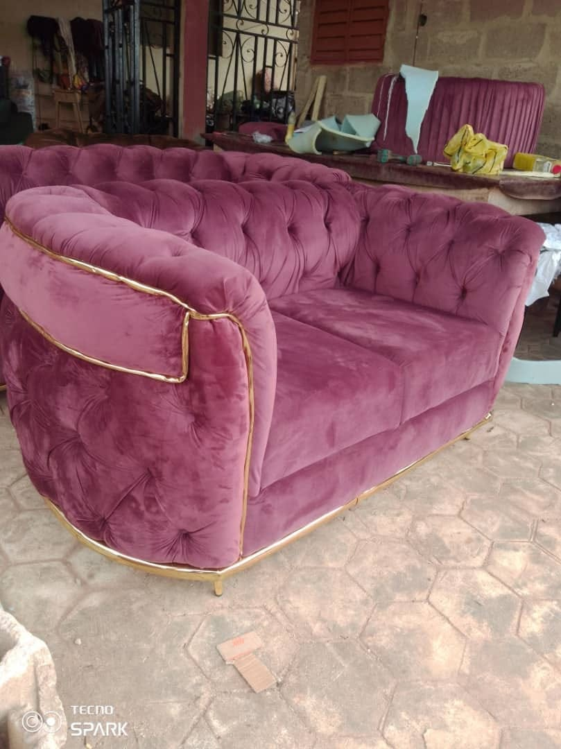 Plum velvet tufted loveseat with gold trim photographed at the workshop
